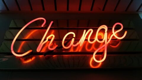 a neon sign that says change on it