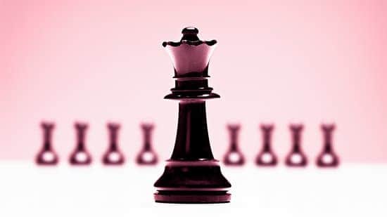 a black and white chess piece on a pink background
