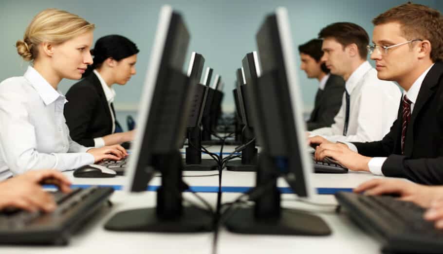 a group of business people working on computers