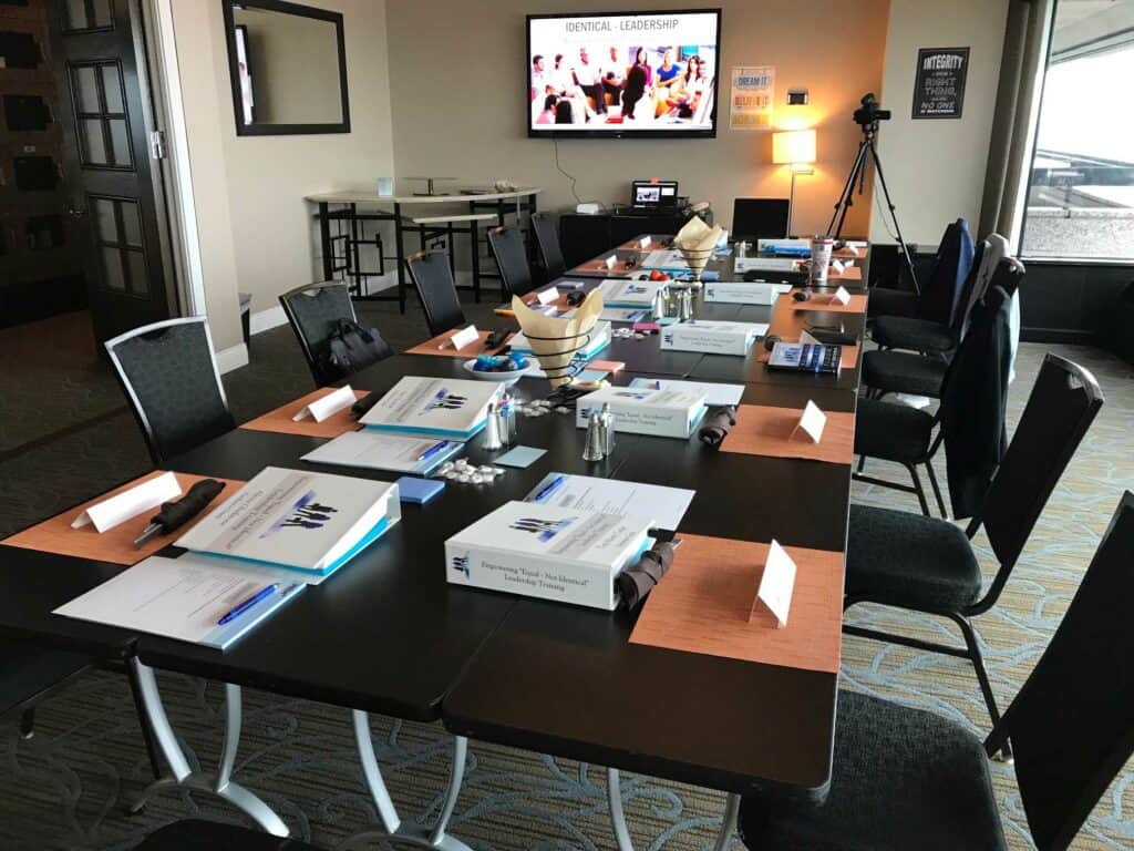 a long table with several chairs and papers on it