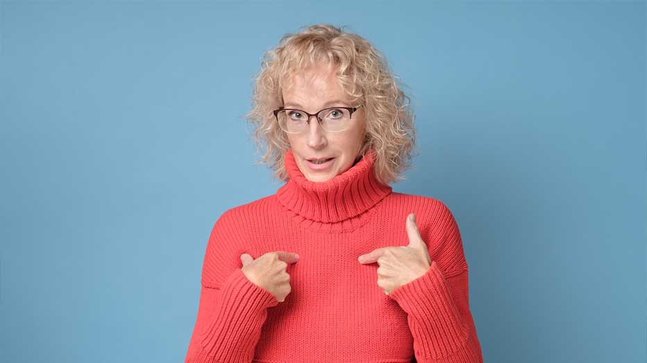 a woman in a red sweater pointing at something