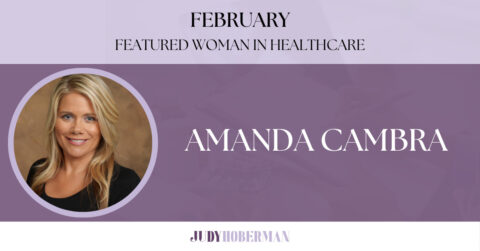 Amanda Cambra in a black top is smiling for the camera